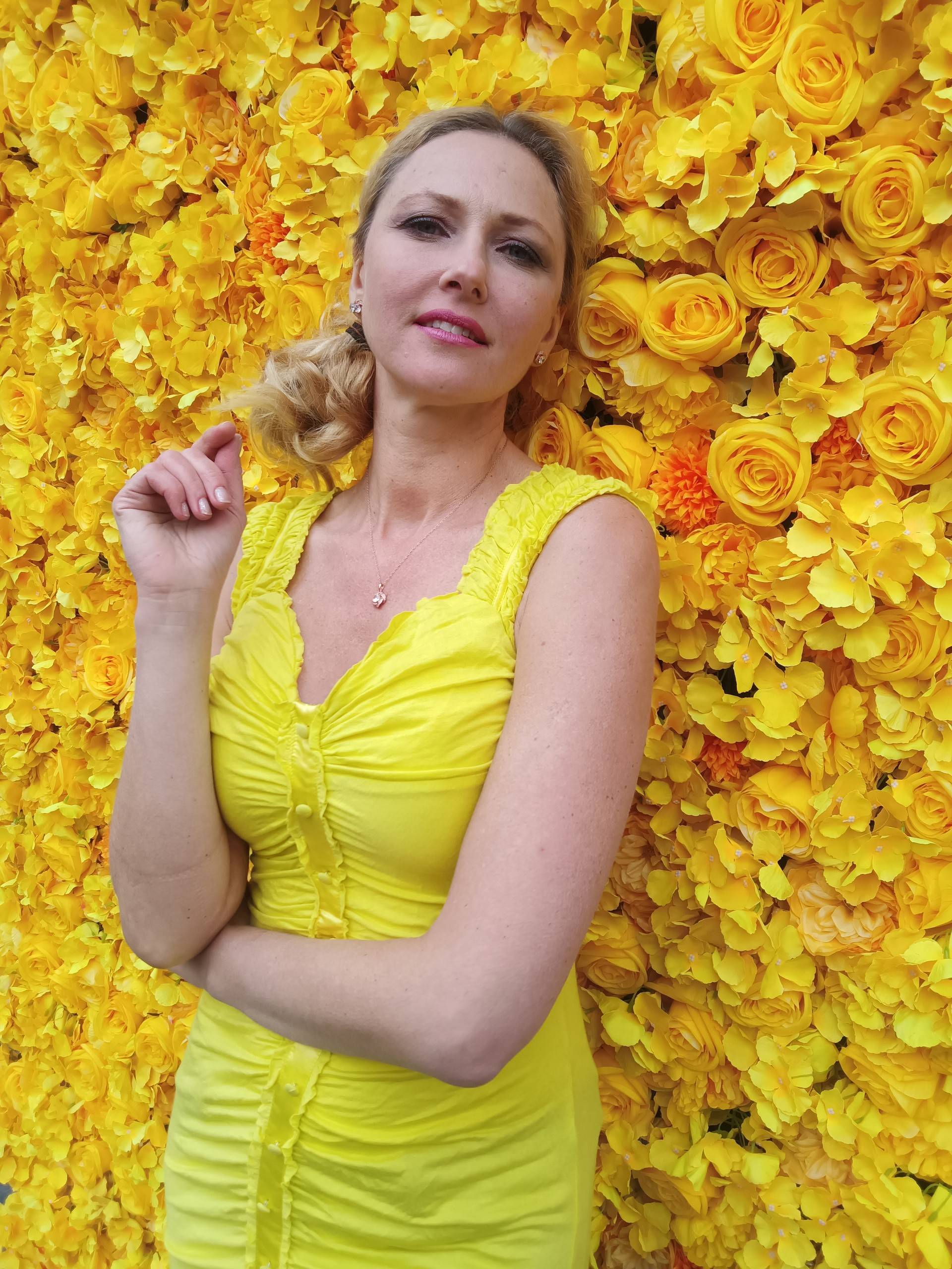 an image of a lady with a flower wall background