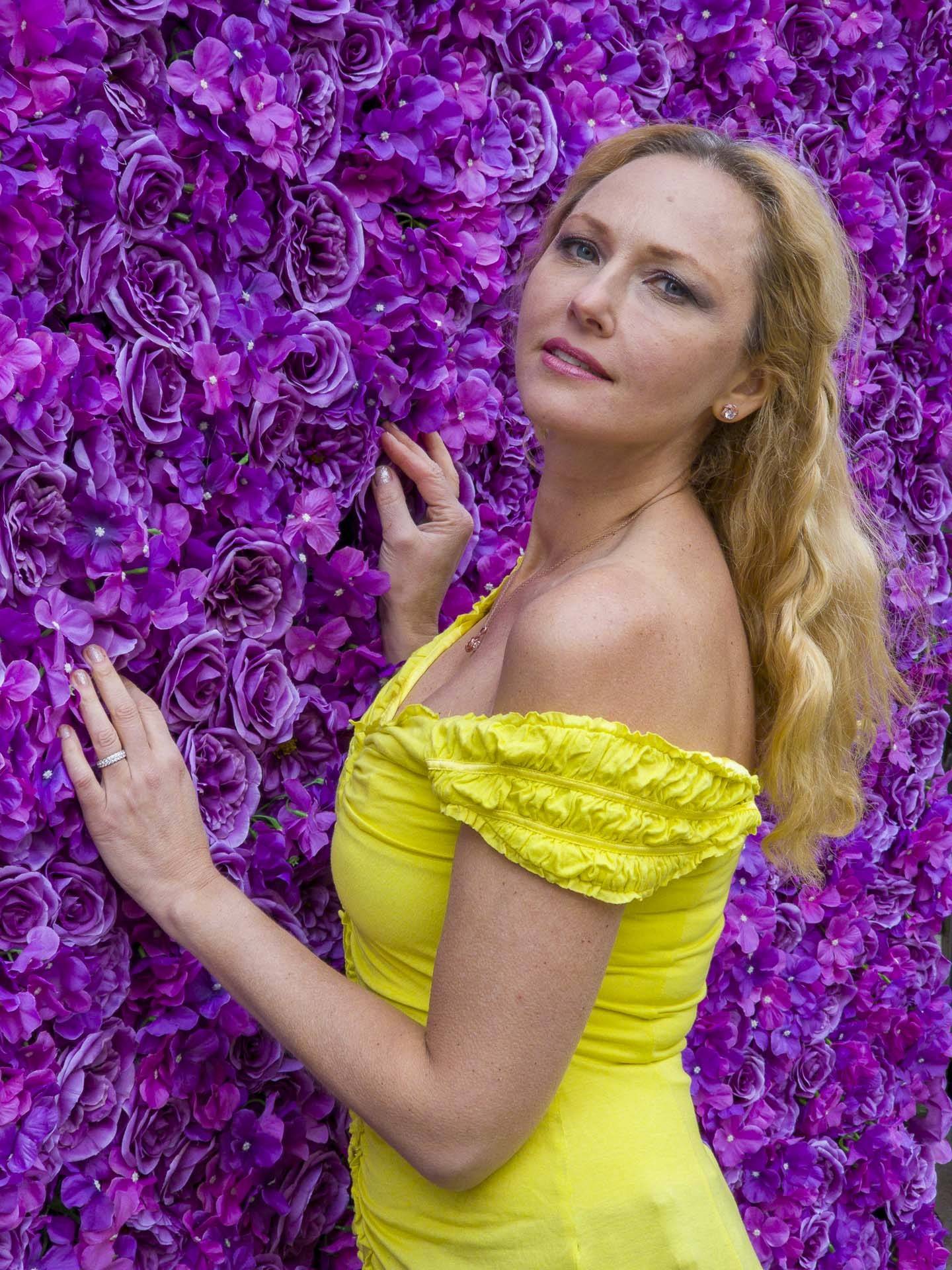 image of lady against a flower wall