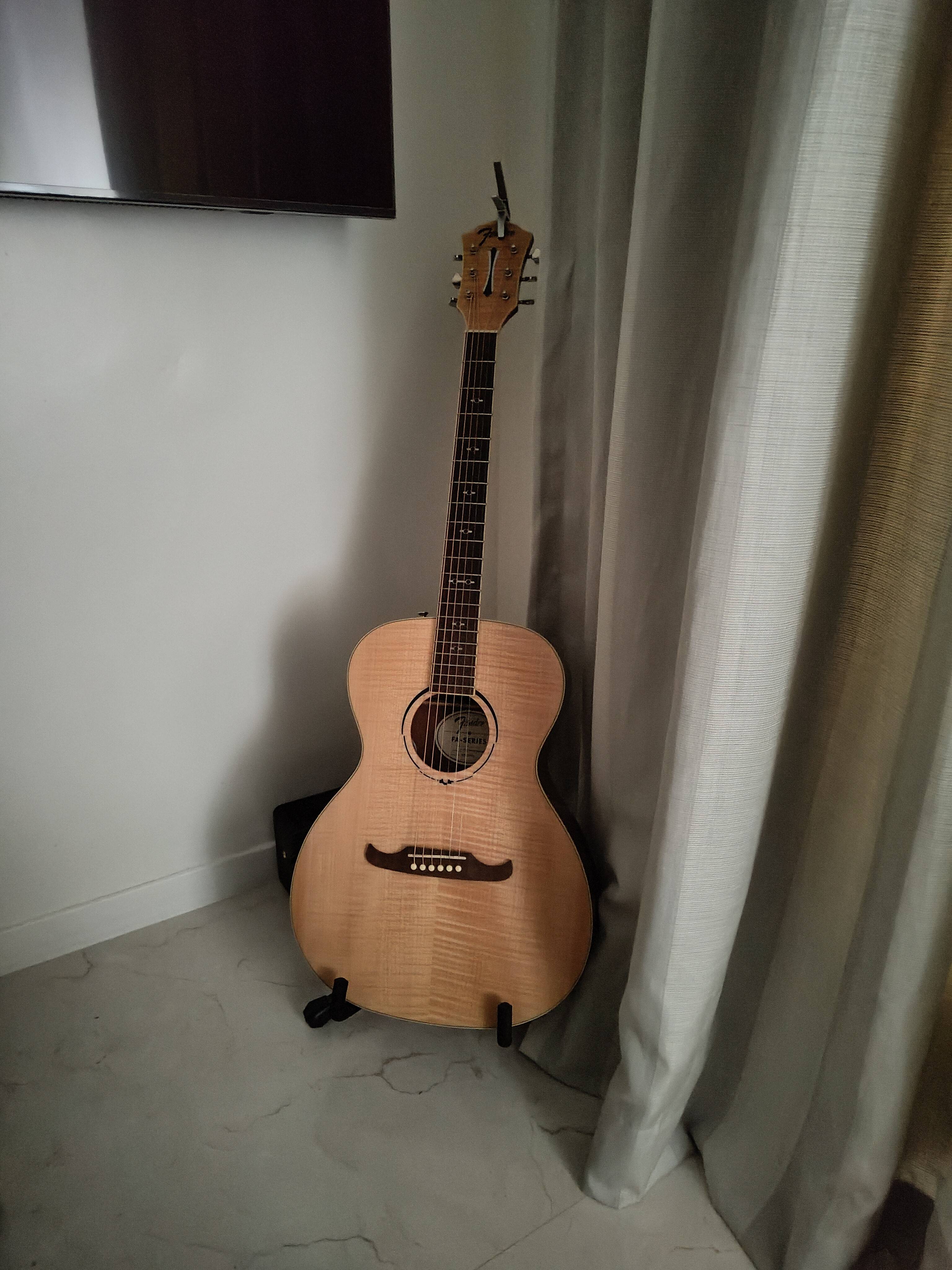 an image of a guitar placed in a dimly lit room
