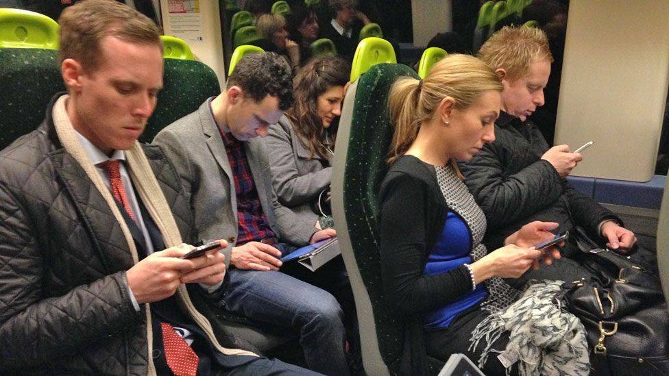 Commuters on phones