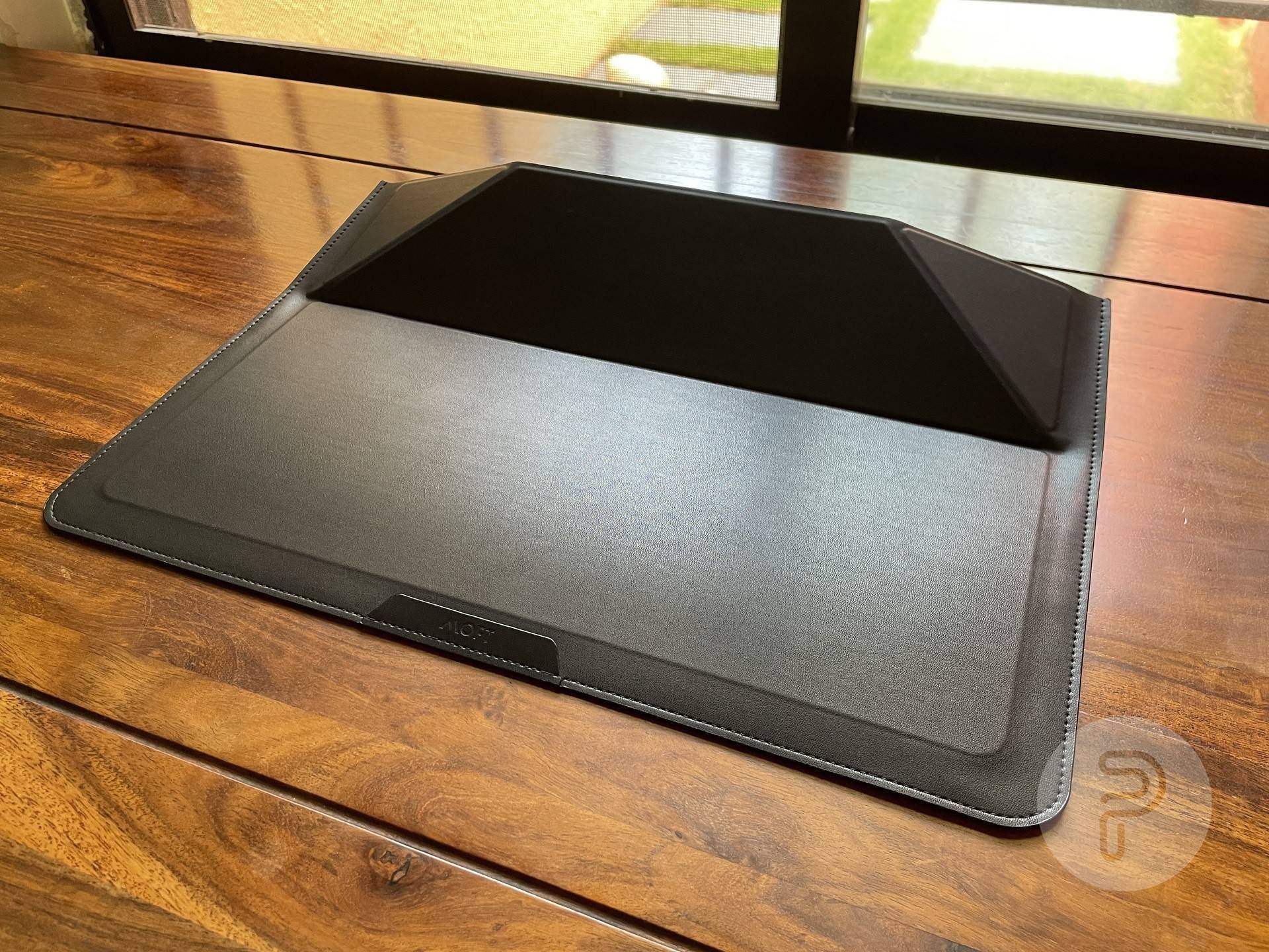 MOFT Laptop Sleeve placed on a table in its 15-degree mode